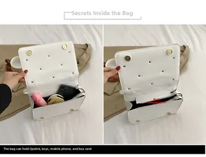Detail view of the white quilted crossbody bag interior with gold studs and large main pocket