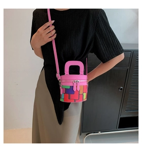 Detail view of colorful geometric block pattern on the pink cylinder bucket bag