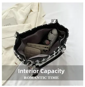 Detailed view of the plaid tote bag's internal capacity with wallet, phone, and umbrella