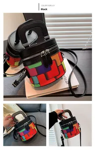 Detail view of colorful geometric pattern cylinder bucket bag with black leather handle