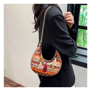 Détail du sac hobo bohème avec jacquard rouge géométrique et pampilles multicolores