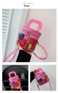 Detailed view of pink cylinder bag with colorful geometric patterns and silver zippers