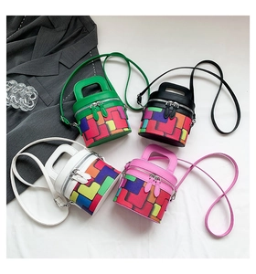 Flat lay of colorful cylinder bucket bags in green, black, white, and pink options