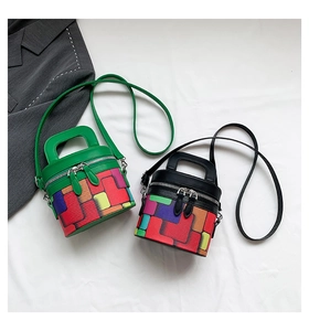 Detailed top view of green and black cylinder bags with vibrant geometric pattern