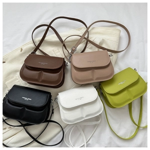 Flat lay of mini square flap crossbody bags in five colors with embossed texture