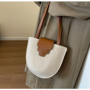 Detail of hand-woven cotton tote bag with premium brown leather strap and contrast stitching