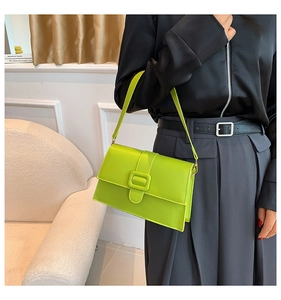 Detail of trendy neon green crossbody bag with glossy finish and square buckle