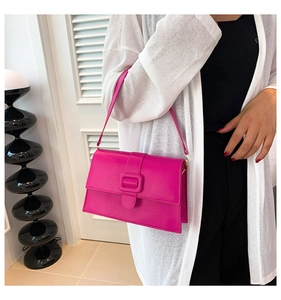 Magenta patent leather square shoulder bag with flap closure and matching large buckle
