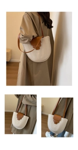 Detail of woven bucket bag with leather strap showing minimalist bohemian design style