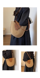 Detail of woven straw bucket bag with brown leather strap and contrast stitching
