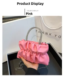 Pink ruched cloud bag featuring rhinestone handle and silver chain strap details