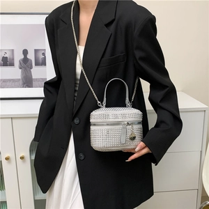 Elegant silver rhinestone crossbody bag with metal chain strap worn on black blazer
