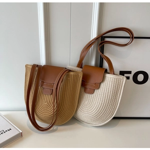 Detailed close-up of woven cotton shoulder bags with contrast leather flaps and straps