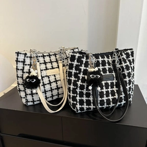 Classic plaid tweed tote bag with black fuzzy charm and leather brand tag decoration
