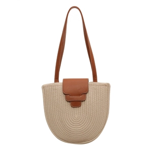 Minimalist woven cotton rope bucket bag with caramel leather flap and white stitching detail