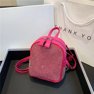 Detail of fuchsia mini backpack with silver rhinestones and double zipper closure
