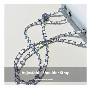Detail of adjustable white leather chain strap with silver ball slider on shoulder bag