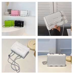 Detail of mini wavy textured crossbody bags with silver chain straps in four pastel colors