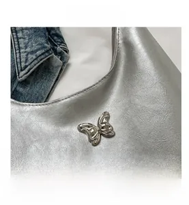 Detailed macro view of silver PU leather texture and butterfly metal buckle closure