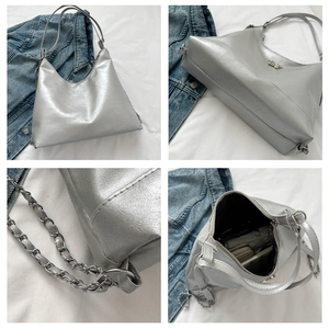 Detail of silver metallic PU bag featuring bear hardware and braided chain shoulder strap