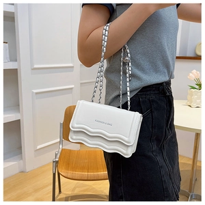 Detail of white wave-edge crossbody bag with FASHION & BAG print and metal chain strap
