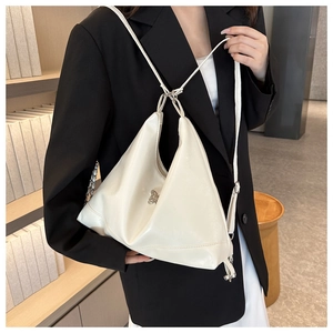 Close-up of white soft PU leather hobo bag featuring silver rabbit charm and chain strap