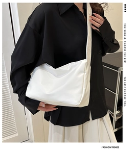 Close-up of white padded nylon crossbody bag featuring soft textured quilted material