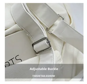 Close-up of high-density canvas bag with adjustable wide strap and metal buckle detail