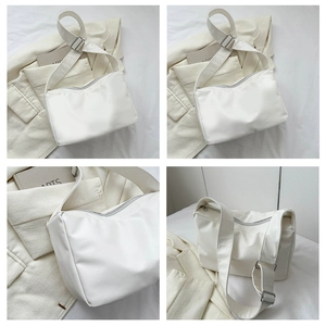 Detail view of the white waterproof nylon shoulder bag with adjustable wide strap and zipper