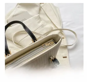 Detailed macro view of the smooth golden zipper and woven texture on a chic tote bag