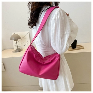 Chic rose pink oversized hobo shoulder bag styled with a white dress for a casual look