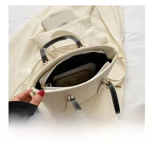 Internal view of the vertical striped bucket bag showing space for a phone and wallet