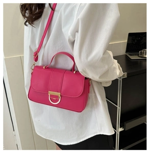 Detail of fuchsia PU leather small square bag with golden handle and horseshoe buckle