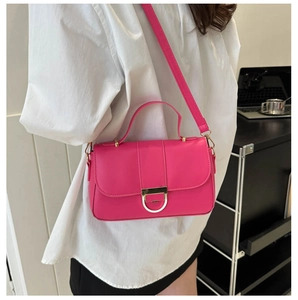 Detail of trendy rose red square handbag with golden D-clasp buckle and leather handle