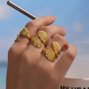 Minimalist 18k gold plated stainless steel leaf rings set in a delicate open design