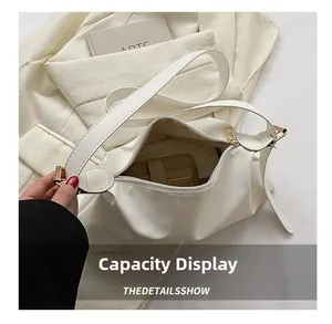 Capacity display of soft cream white shoulder bag with gold zipper and interior card holder