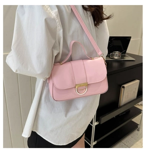 Close-up of pink rectangular handbag with gold D-buckle and sleek PU leather finish