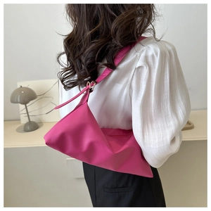 Magenta soft PU leather shoulder bag shown on model wearing white lantern sleeve shirt