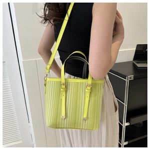 Lime yellow bucket bag featuring vertical texture and adjustable strap in a modern setting