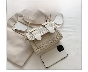 Size comparison of a cream woven crossbody bag next to a smartphone showing capacity