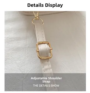 Detail of adjustable cream faux leather shoulder strap with gold-plated metal buckle