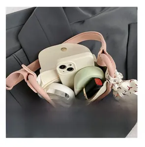 Detail view of mini bag interior capacity holding phone, lipstick, and makeup essentials