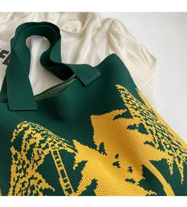 Close-up of thick green knit tote bag featuring a yellow landscape jacquard pattern