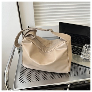 Beige large capacity soft PU leather crossbody bag with adjustable wide strap on cart