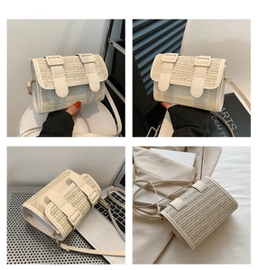 Detail shot of a small beige straw woven crossbody bag with white leather flap and buckles