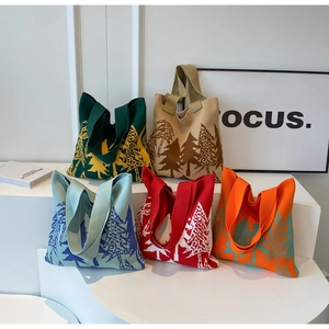Detail of five knit tote bags with pine tree patterns and reinforced woven handles
