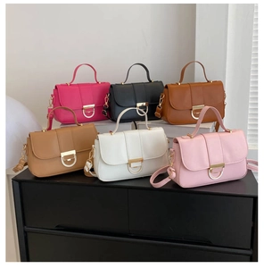 Close-up of stylish small crossbody bags in six vibrant colors with gold metal buckles