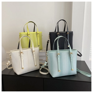 Detailed vertical texture of minimalist bucket bags in four colors with gold metal hardware