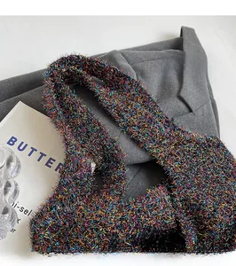 Close-up of colorful shimmering knit strap on a casual shoulder bag with textured finish