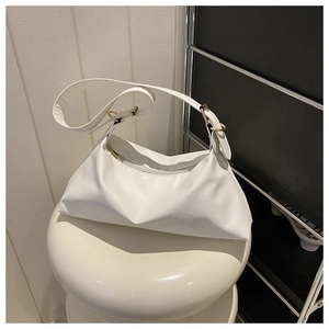 Detail of white hobo bag with soft matte leather texture and golden zipper hardware